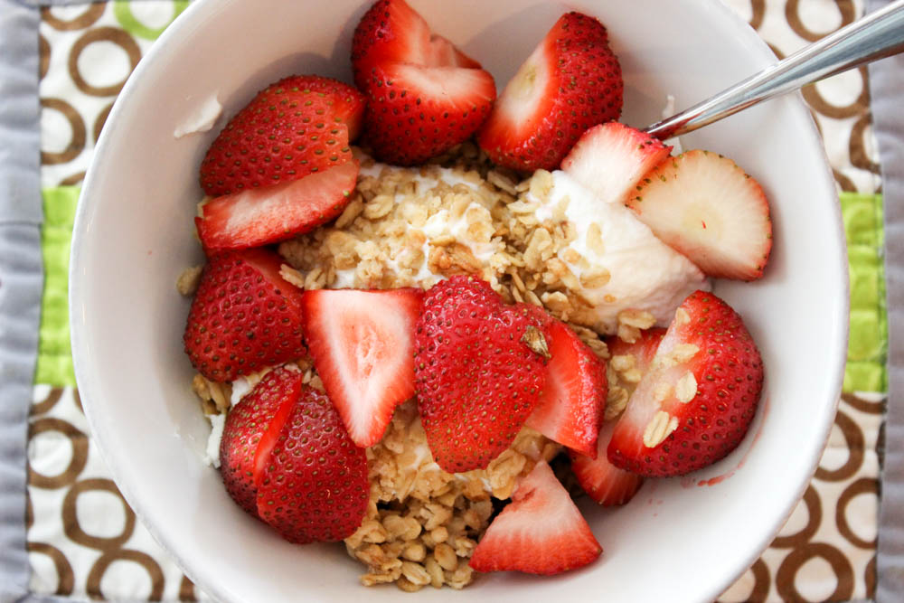 greek yogurt topped with strawberries and granola